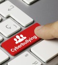 Cyberbullying keyboard key. Finger