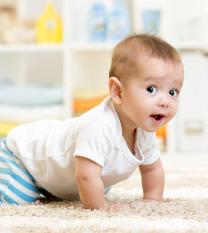 crawling funny baby boy indoors at home